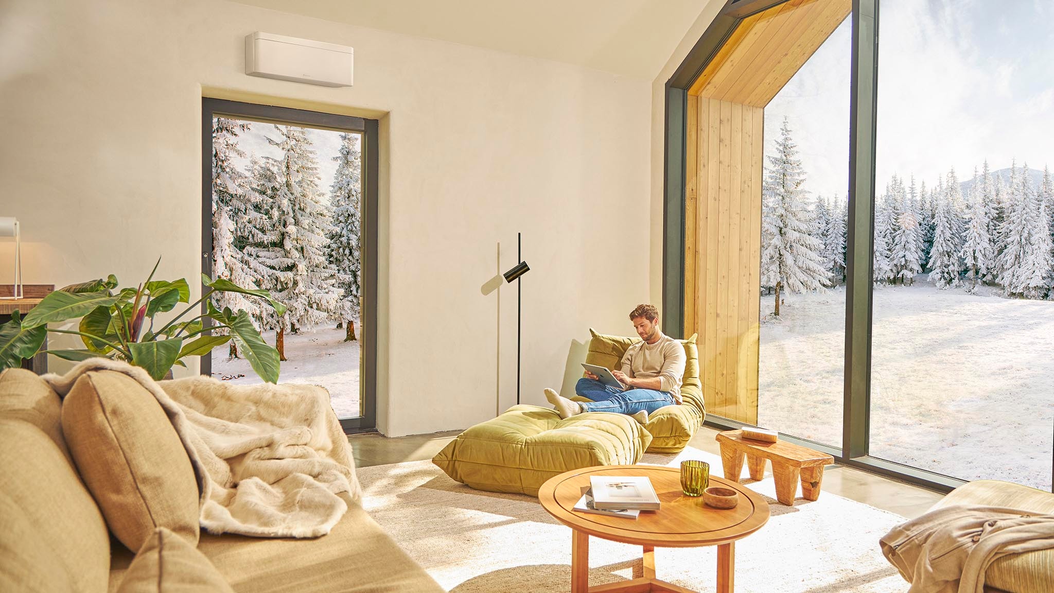 Man sitting in couch and enjoying heating with air conditioner