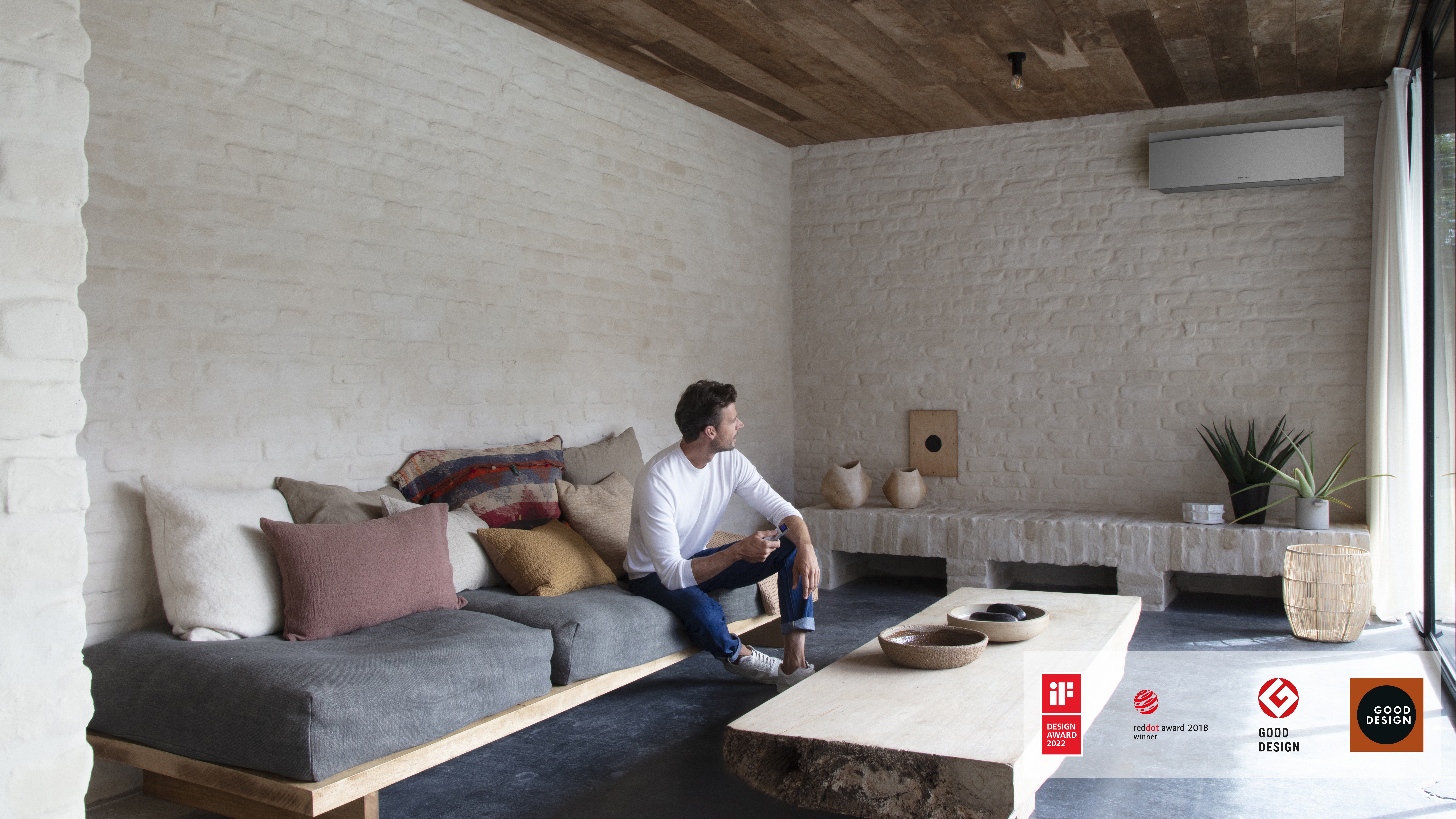 Man controlling his air conditioner in the living room with a remote