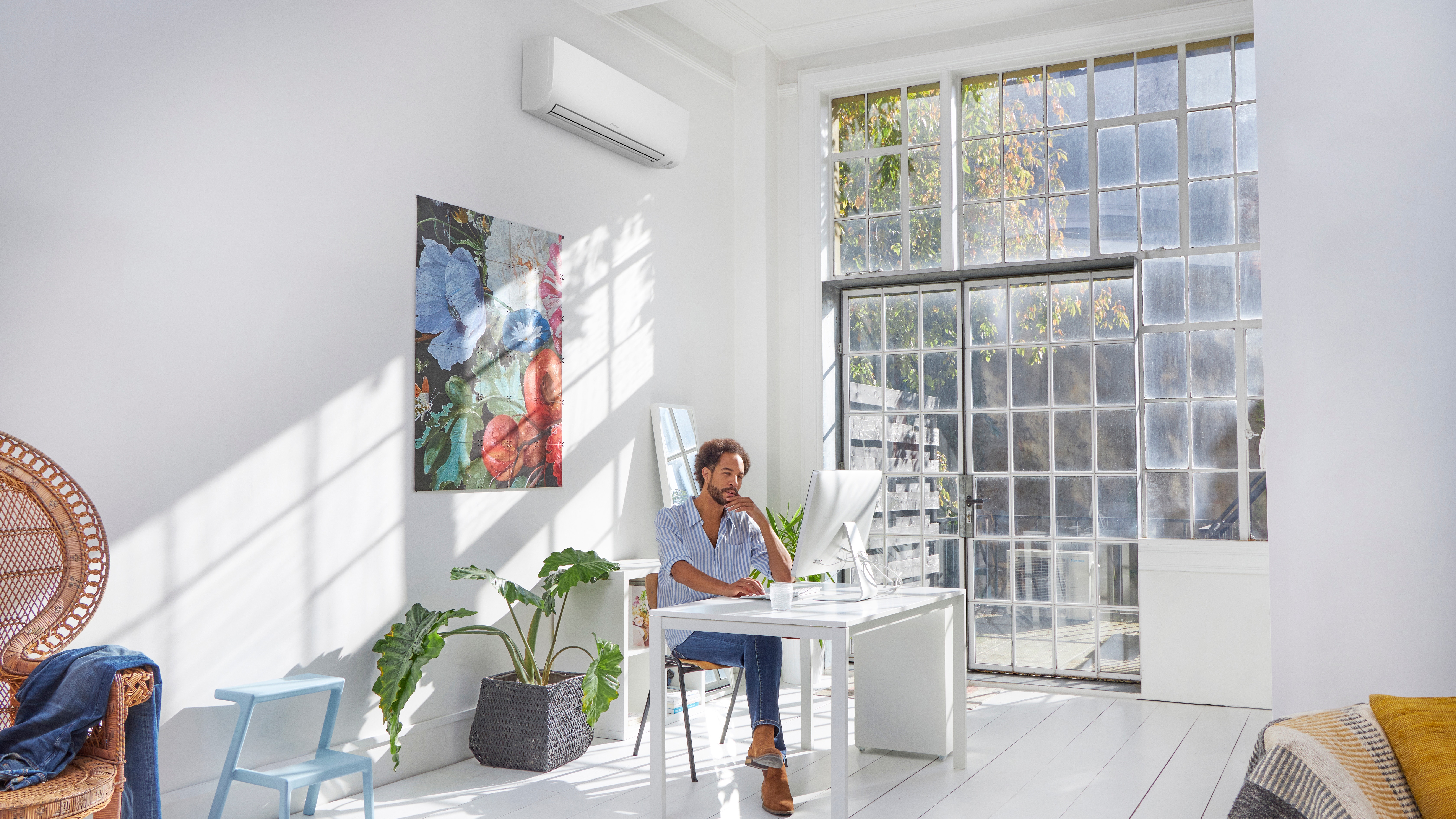 Man in his laptop in living room