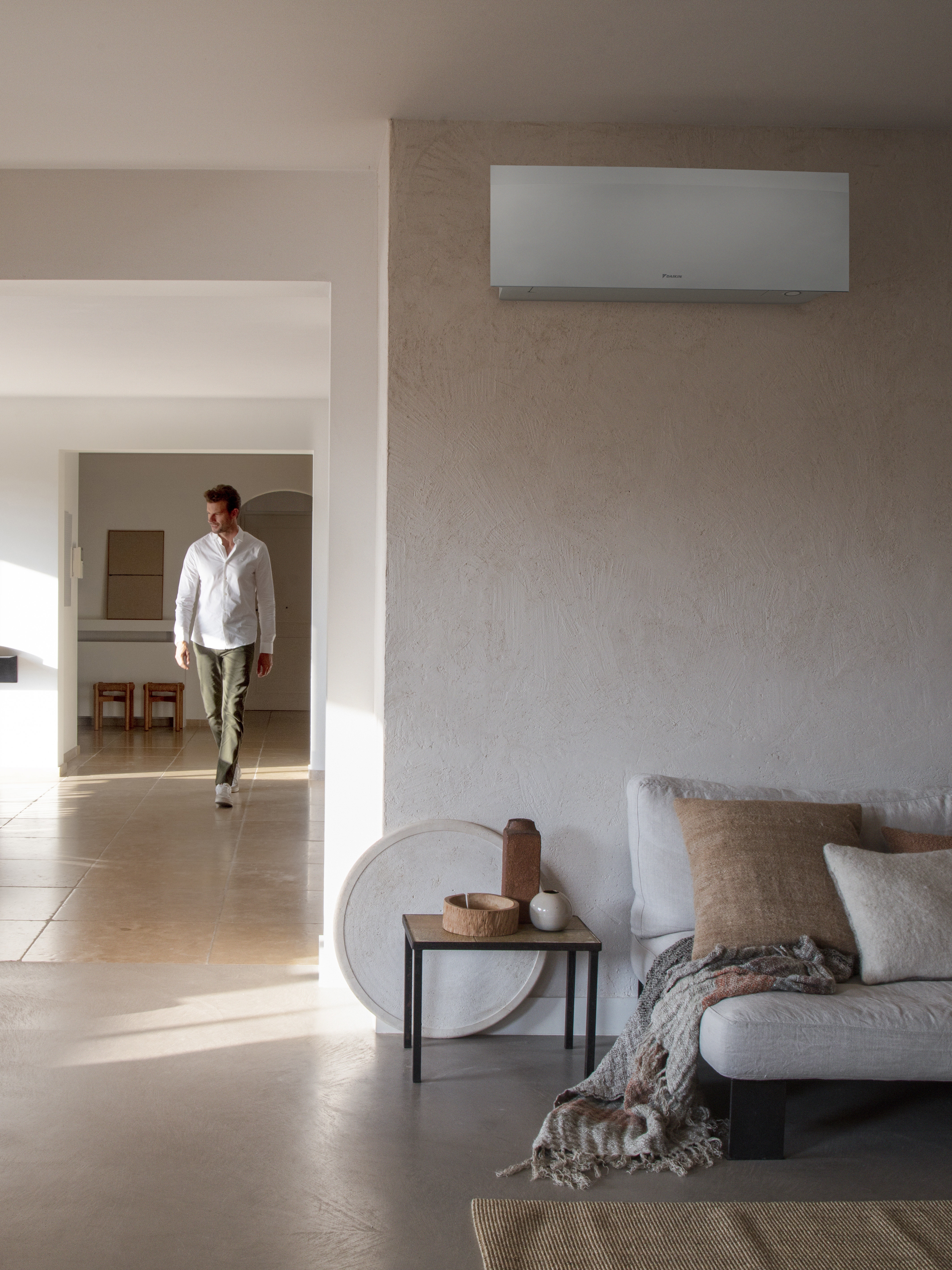 Man crossing his living room and enjoying cool air