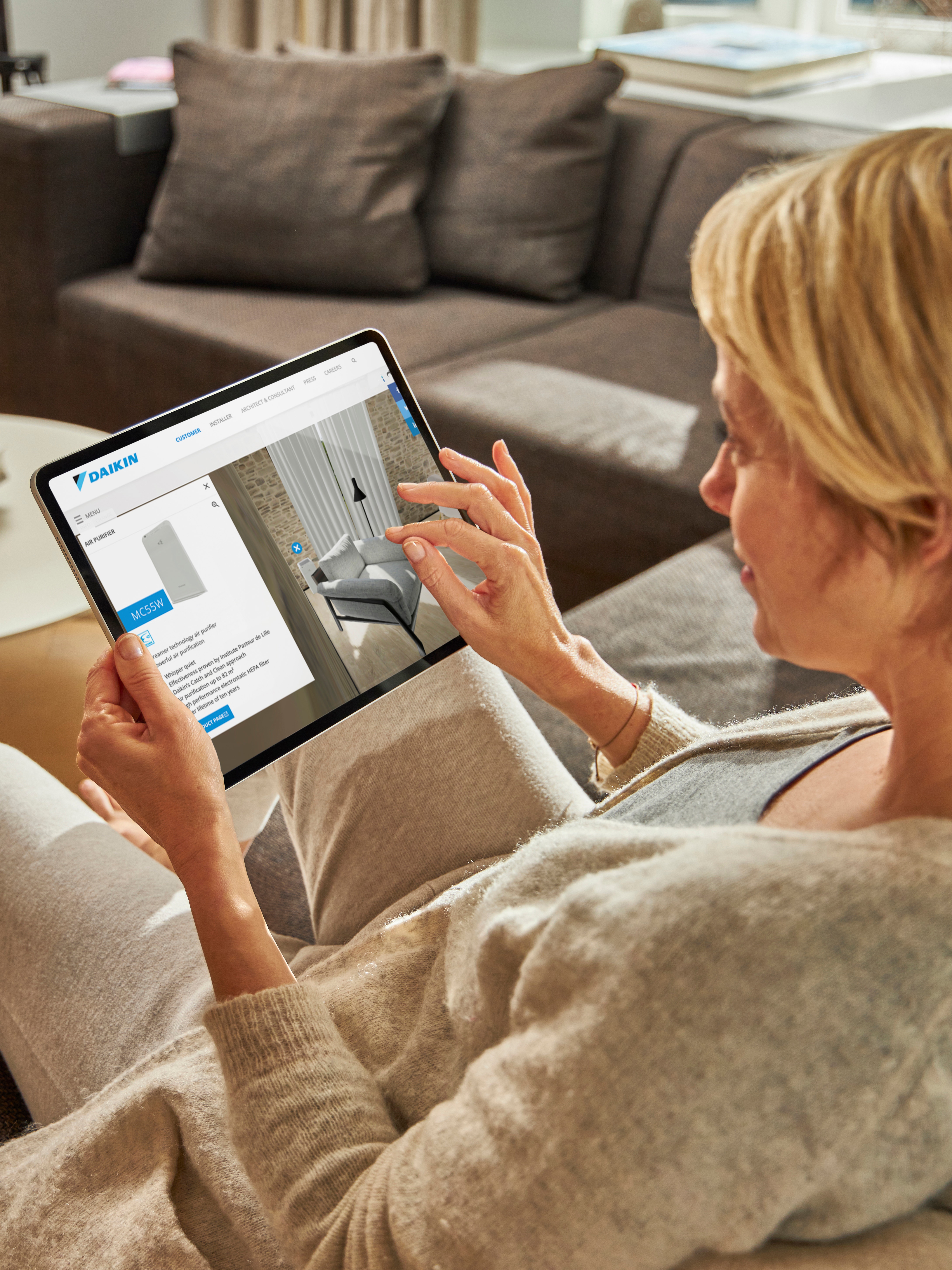 Person visiting the virtual experience centre to see an air purifier via a tablet