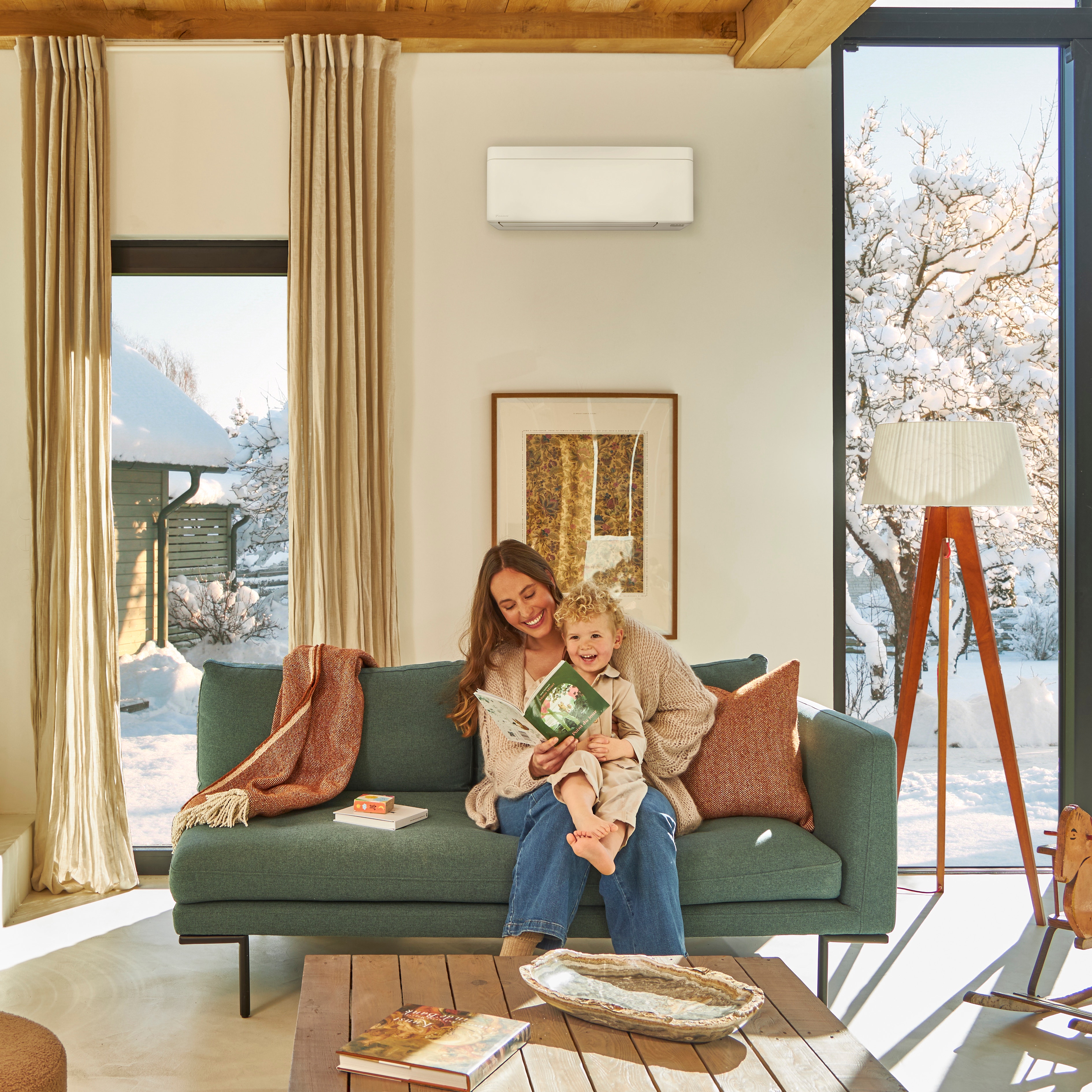 A woman reading a book with her kid